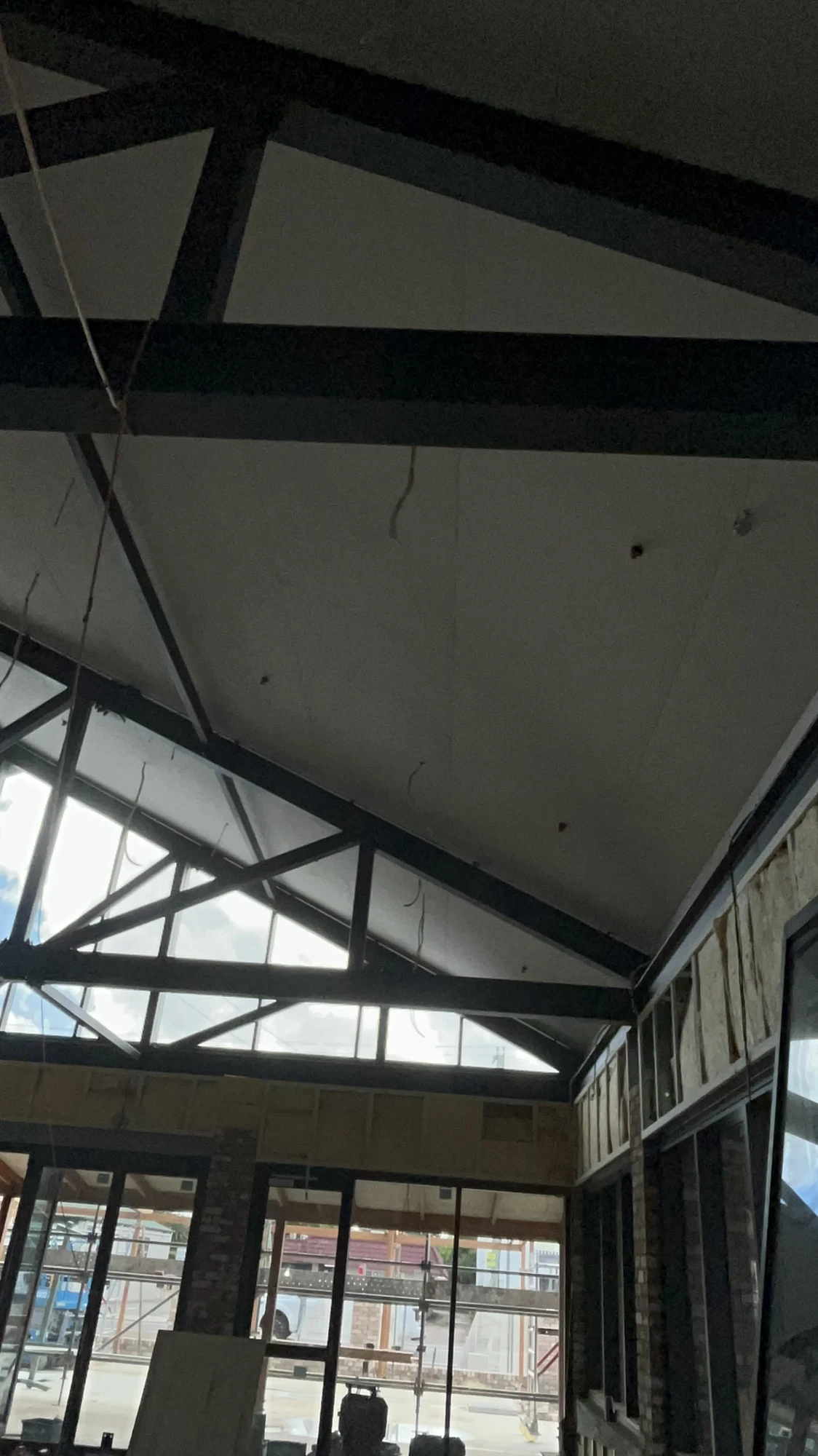Close view of ceiling surfaces and roof trusses