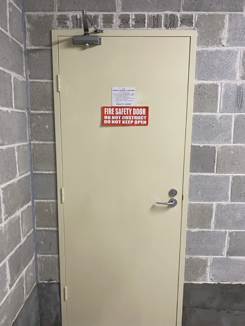 The same door after repainting, with signs and hardware visible